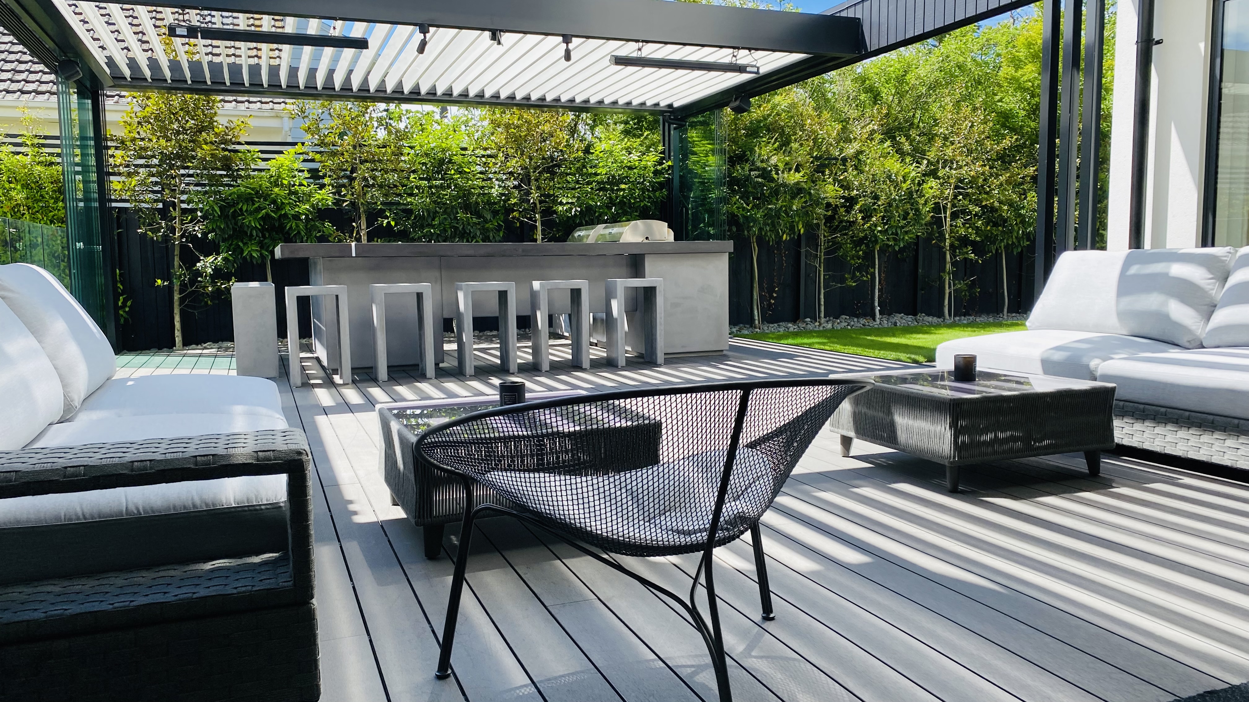 Detail view of weather-protected outdoor entertainment zone with sliding glazing