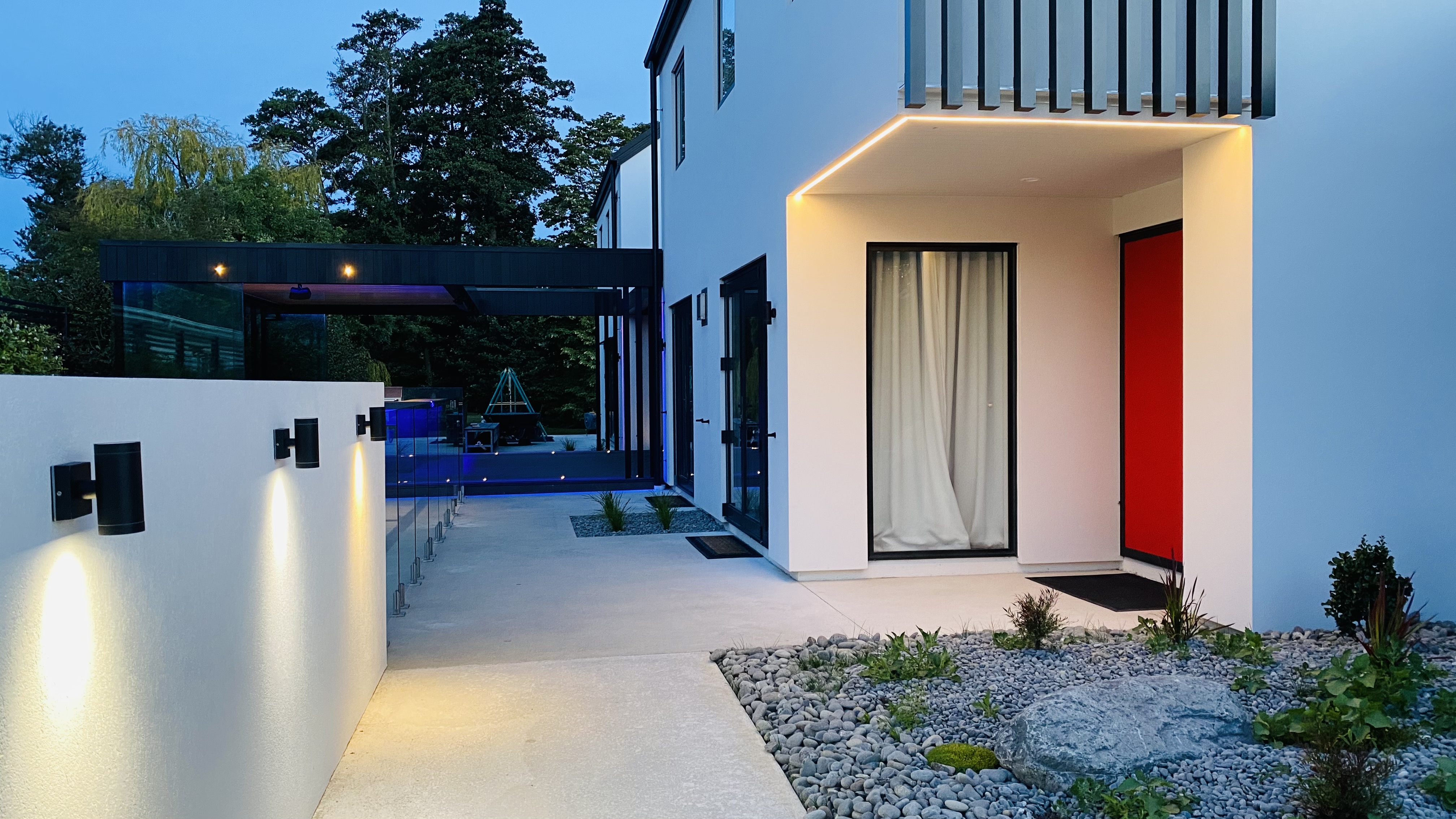 Covered outdoor entertainment area with wind protection and ambient lighting