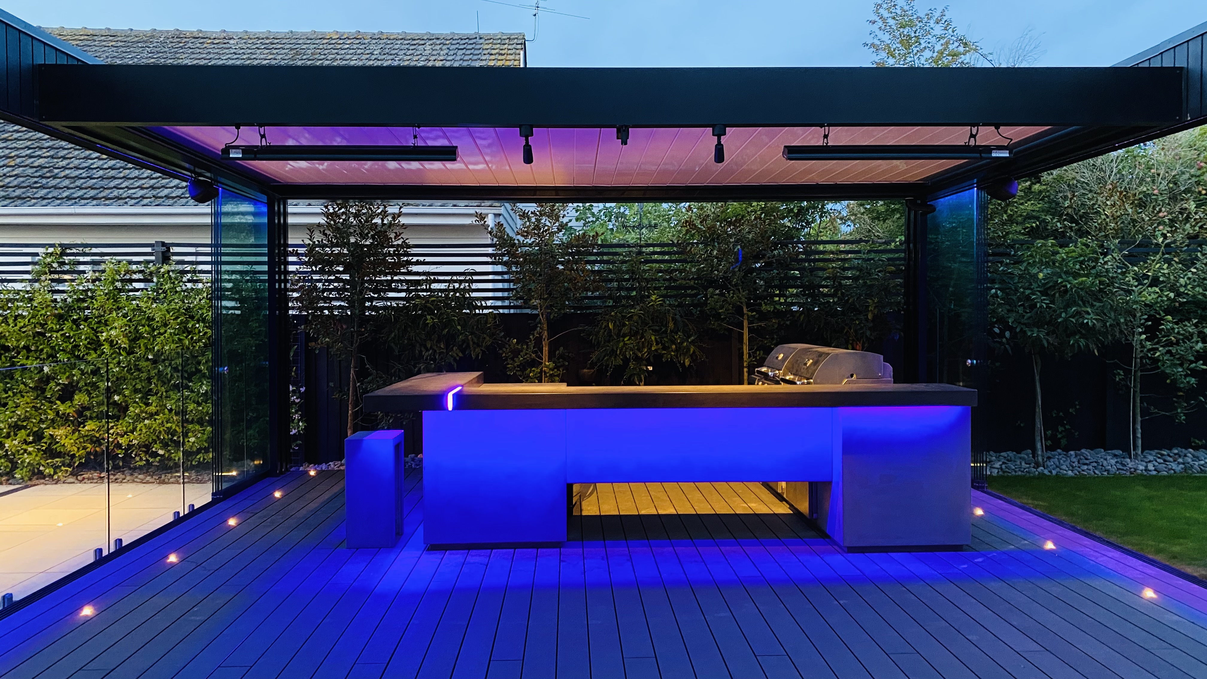 Evening view of louvred roof system over outdoor living space