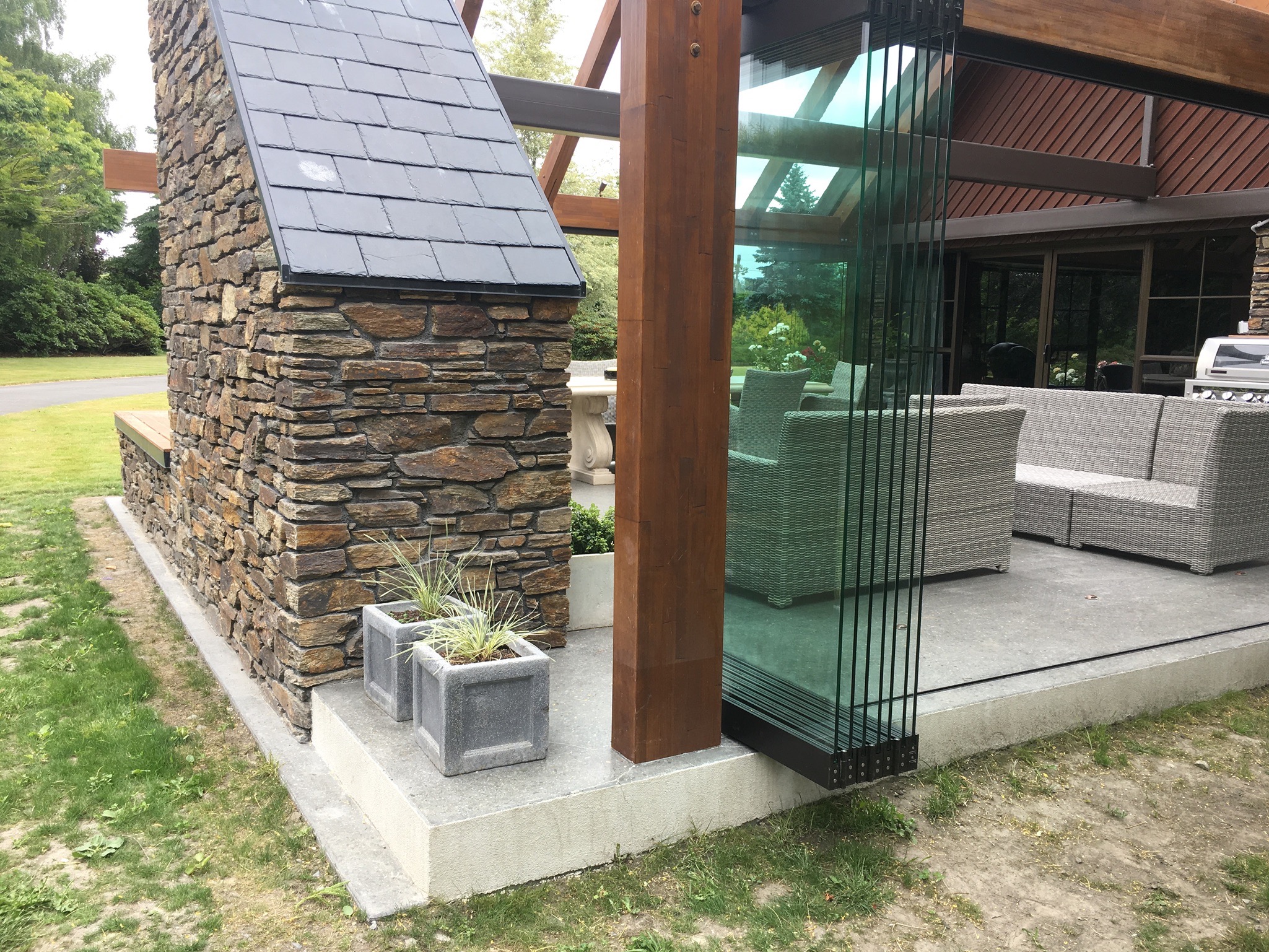 Outdoor dining area strategically protected from prevailing winds