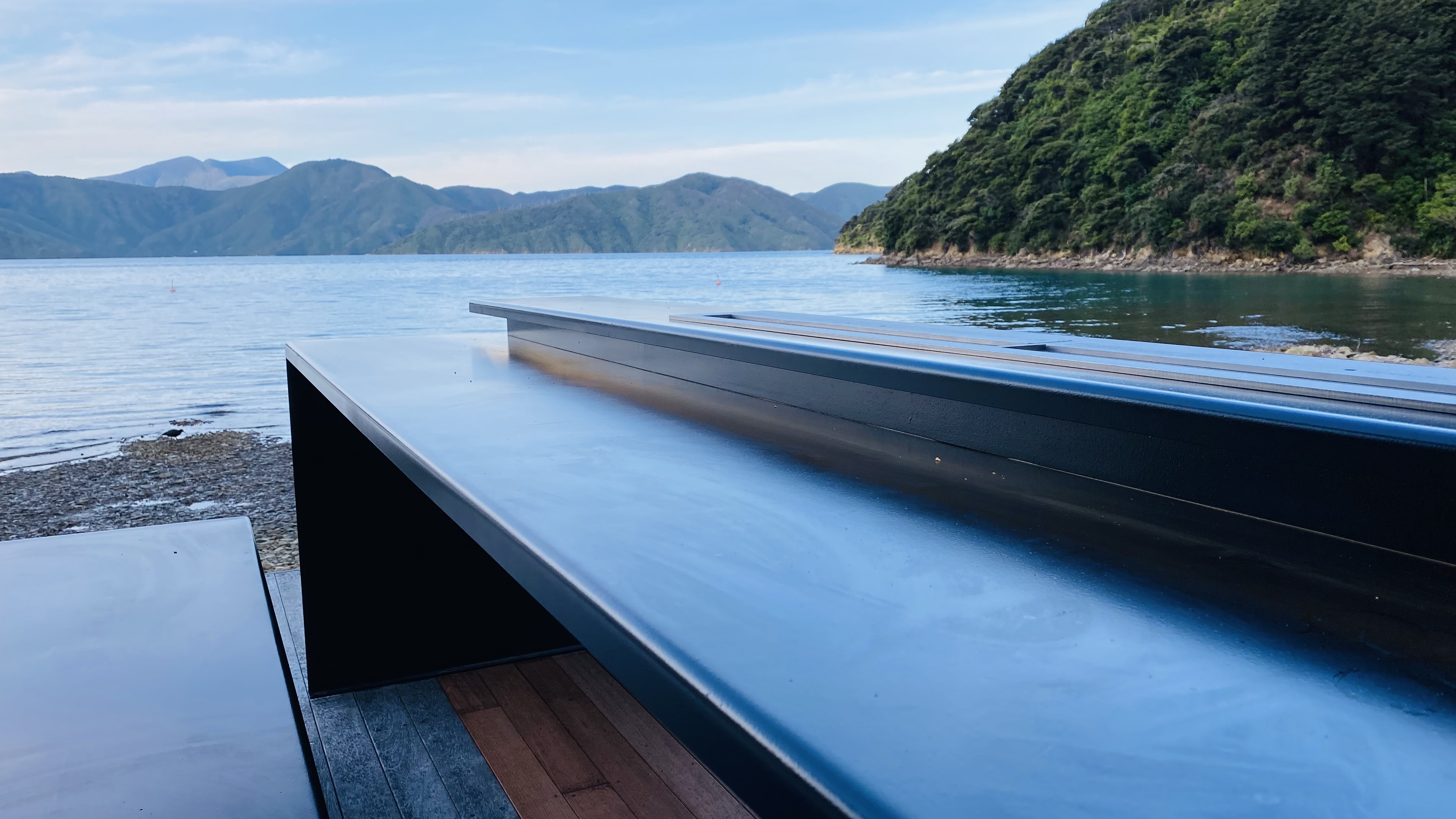 Cantilevered steel table design with no centre support, weighing over 300kg for wind resistance