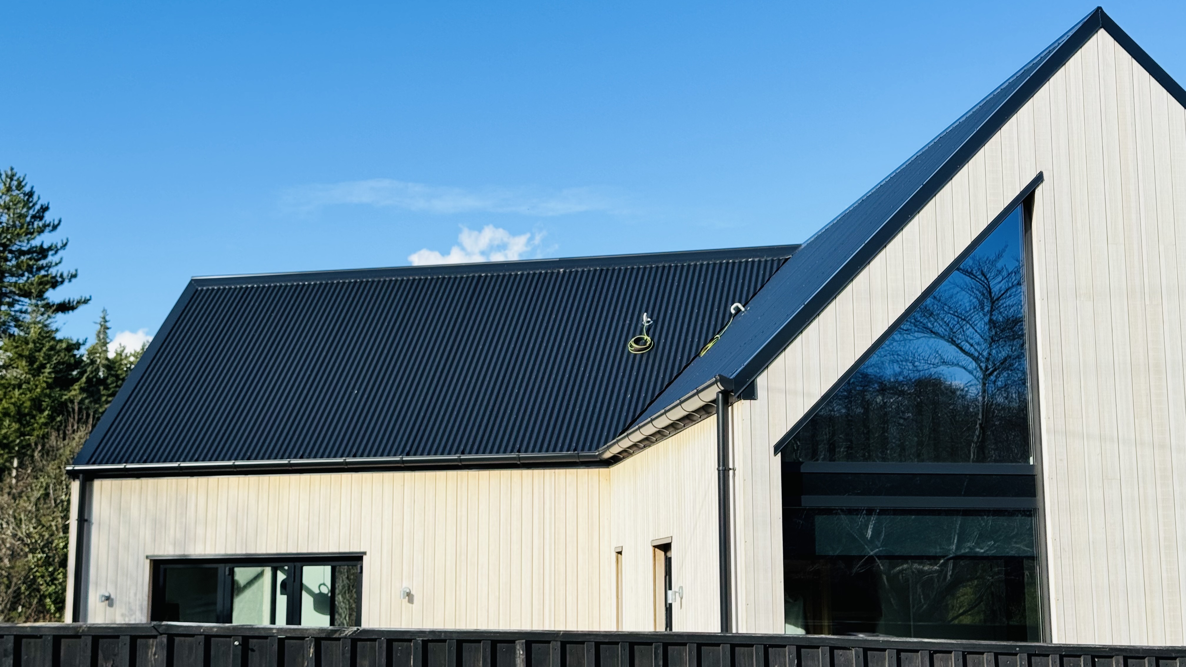 Evening exterior with warm interior lighting through high-performance glazing